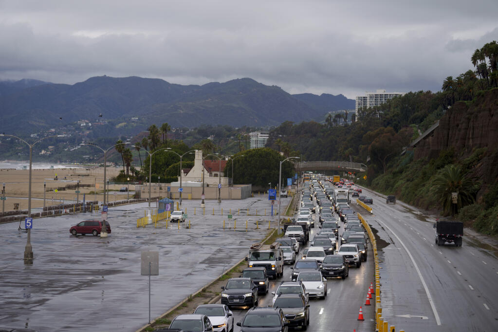 Traffic backed up along Pacific Coast Highway due to flooding in Santa Monica, Calif., Thursday, Feb. 1, 2024. The first of two back-to-back atmospheric rivers is drenching California. Heavy rain and gusty winds began hitting the north on Wednesday and moved south along the coast, snarling the Thursday morning commute in Los Angeles. (AP Photo/Eric Thayer)