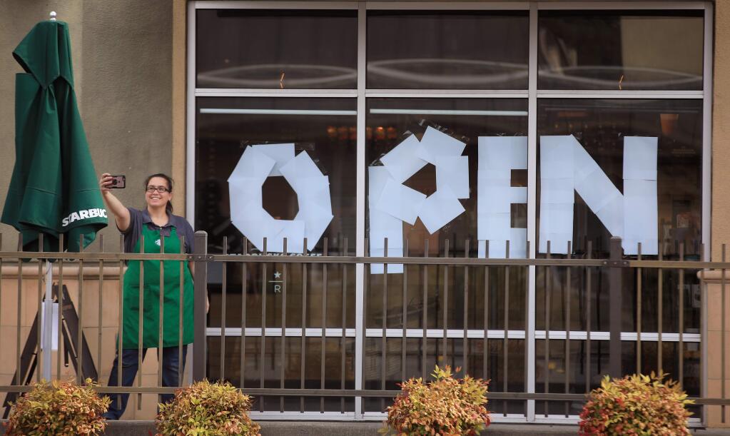 Erica Thayer, a manger of another Starbucks in Santa Rosa, takes a selfie at the Mendocino Avenue store as she helps out, Tuesday, March 17, 2020. The coffee shop is allowing only grab and go service. (Kent Porter/The Press Democrat)