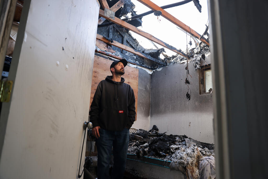 Clinton Gandy looks around his home, which burned Wednesday night, in Sebastopol on Friday, Dec. 2, 2022. Gandy helped build the home through a sweat equity program with Burbank Housing, and plans to rebuild. (Christopher Chung/The Press Democrat)