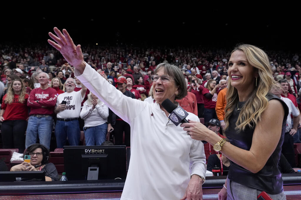 Stanford head coach Tara VanDerveer, center, waves to the crowd after breaking the college basketball record for wins with her team's victory over Oregon State in an NCAA college basketball game, Sunday, Jan. 21, 2024, in Stanford, Calif. (AP Photo/Godofredo A. Vásquez)