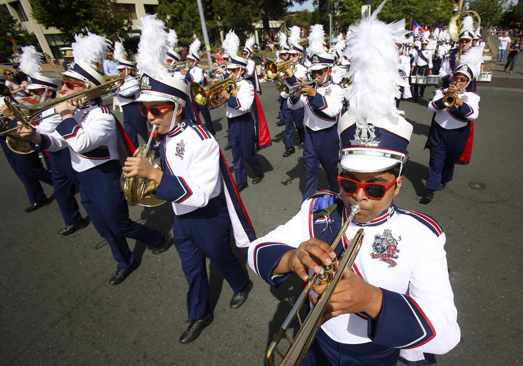 The Rancho Cotate High School marching band makes its way though Saturday's Rose Parade along Fourth Street in Santa Rosa, Saturday, May 17, 2014. (Conner Jay / The Press Democrat file)