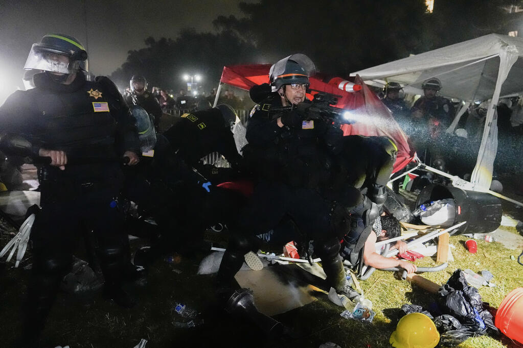 Police advance on pro-Palestinian demonstrators in an encampment on the UCLA campus in Los Angeles during the early hours of May 2, 2024. Photo by Jae C. Hong, AP Photo