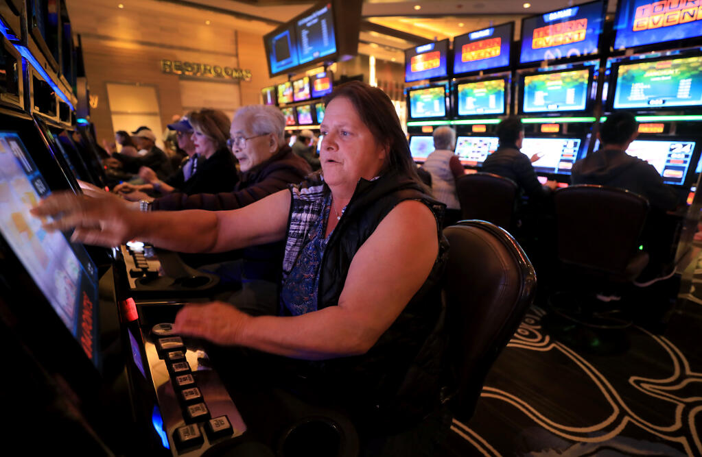 Cathy MacCallum of Santa Rosa plays in an electronic slot tournament during a promotion of the five year anniversary of the Graton Resort and Casino, Friday, Nov. 16, 2018. (Kent Porter / The Press Democrat file)