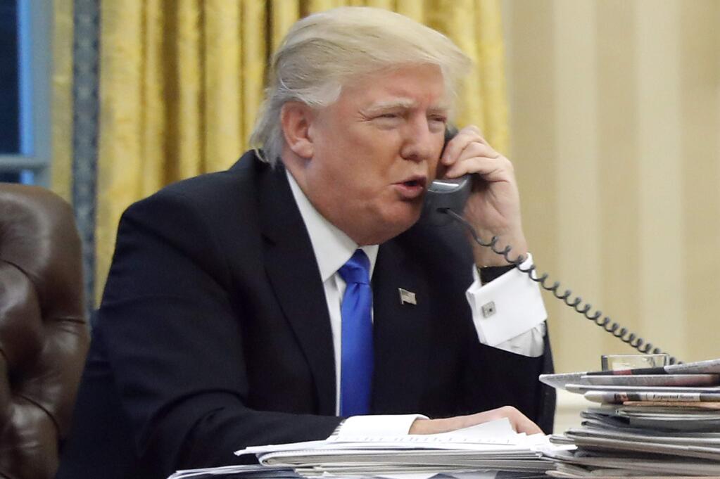 In this photo taken Jan. 28, 2017, President Donald Trump speaks on the phone with Australian Prime Minister Malcolm Turnbull in the Oval Office of the White House in Washington. Transcripts of President Donald Trump's conversations with the leaders of Mexico and Australia in January offer new details on how the president parried with the leaders over the politics of the border wall and refugee policy, with random asides on subjects including drug abuse in New Hampshire. (AP Photo/Alex Brandon)