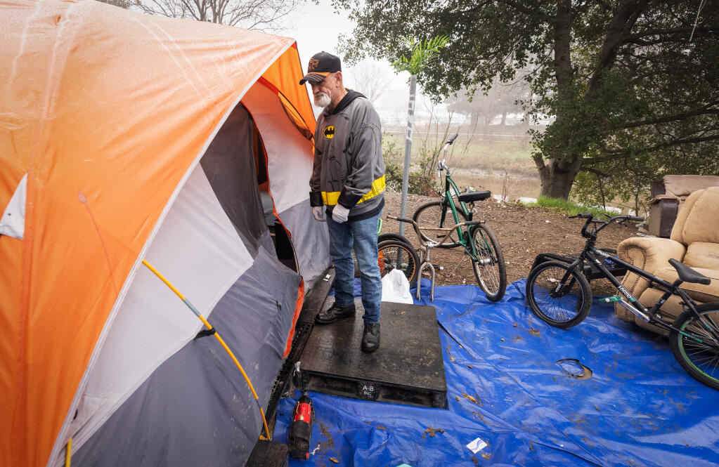 COTS resident Ron Potter checks on friends living in a tent near the Petaluma River while volunteering to help with the annual Sonoma County Point-in-Time Street Count for all populations the homeless Friday, January 27, 2023.  (John Burgess/The Press Democrat)