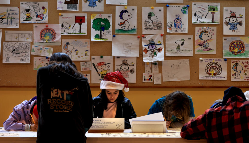 Kids and parents alike color their favorite “Peanuts” characters at the Charles M. Schulz Museum in Santa Rosa, Saturday, Nov. 18, 2023, as part of a celebration for 50 years of “A Charlie Brown Thanksgiving.” (Kent Porter / The Press Democrat file)
