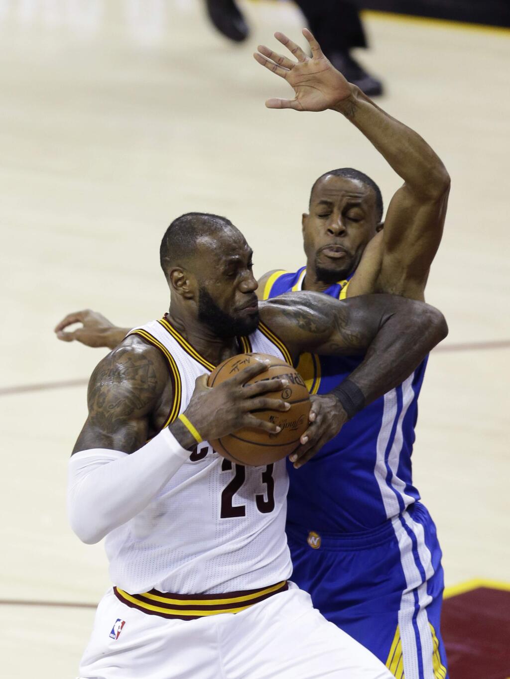 Cleveland Cavaliers forward LeBron James (23) drives on Golden State Warriors forward Andre Iguodala, right, during the second half of Game 3 of basketball's NBA Finals in Cleveland, Wednesday, June 7, 2017. (AP Photo/Tony Dejak)