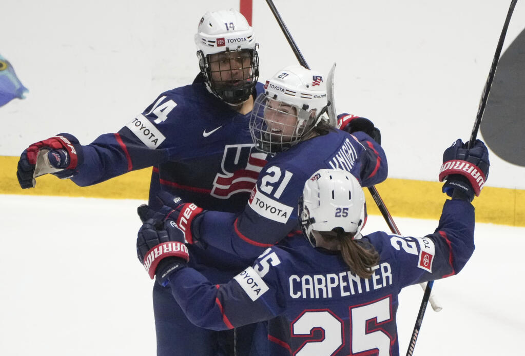 The United States’ Laila Edwards celebrates after her goal over Finland with teammates Hilary Knight and Alex Carpenter during the second period in the semifinals of the women’s world hockey championships Saturday, April 13, 2024, in Utica, New York.. (Christinne Muschi / Canadian Press)