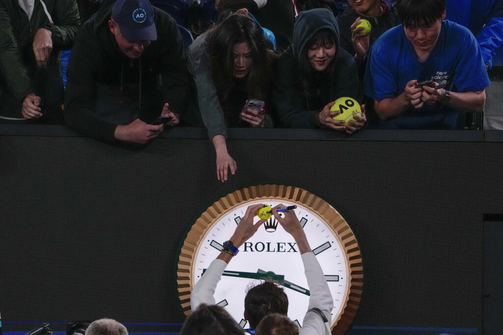 Daniil Medvedev of Russia signs autographs after defeating Emil Ruusuvuori of Finland in their second round match at the Australian Open tennis championships at Melbourne Park, Melbourne, Australia, Friday, Jan. 19, 2024. (AP Photo/Andy Wong))