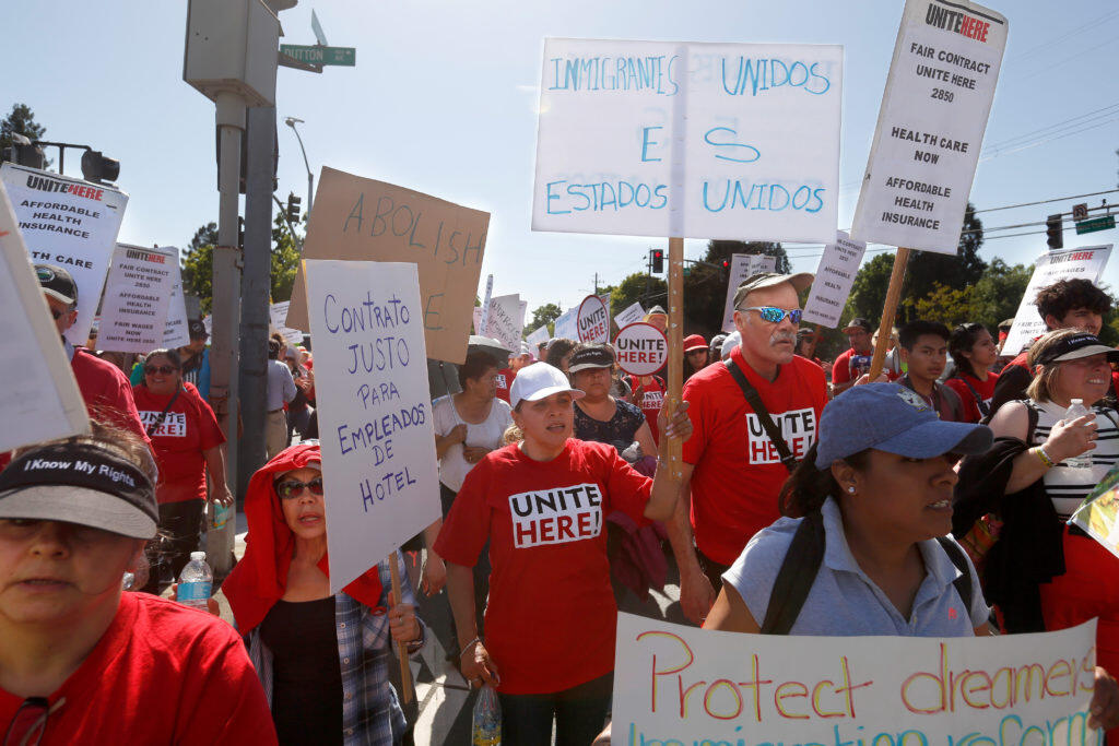 Aracele Nelson, center, and other supporters of Unite Here! Local 2850, a union for hotel, food service and gaming workers, take part in a May Day march in support of workers’ rights and immigration reform, in Santa Rosa, California, on Tuesday, May 1, 2018. (ALVIN JORNADA/THE PRESS DEMOCRAT)