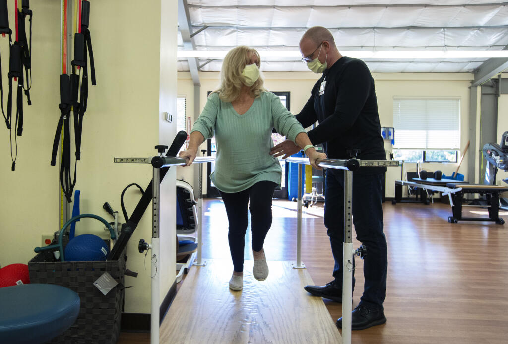 Physical therapist Austin Nickerson guides patient Millie Gilson through her exercise regimen at the Sonoma Valley Hospital Hand and Physical Therapy facility on Sonoma Highway in Boyes Hot Springs on Friday, Nov. 17, 2023. (Robbi Pengelly/Index-Tribune)