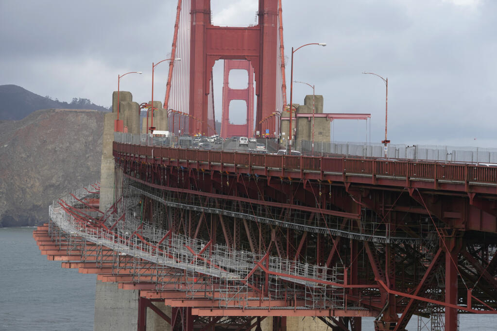 A suicide deterrent net is seen under construction on the Golden Gate Bridge in San Francisco, Wednesday, Dec. 6, 2023. The barrier at the bridge is near completion more than a decade after officials approved it. (AP Photo/Eric Risberg)