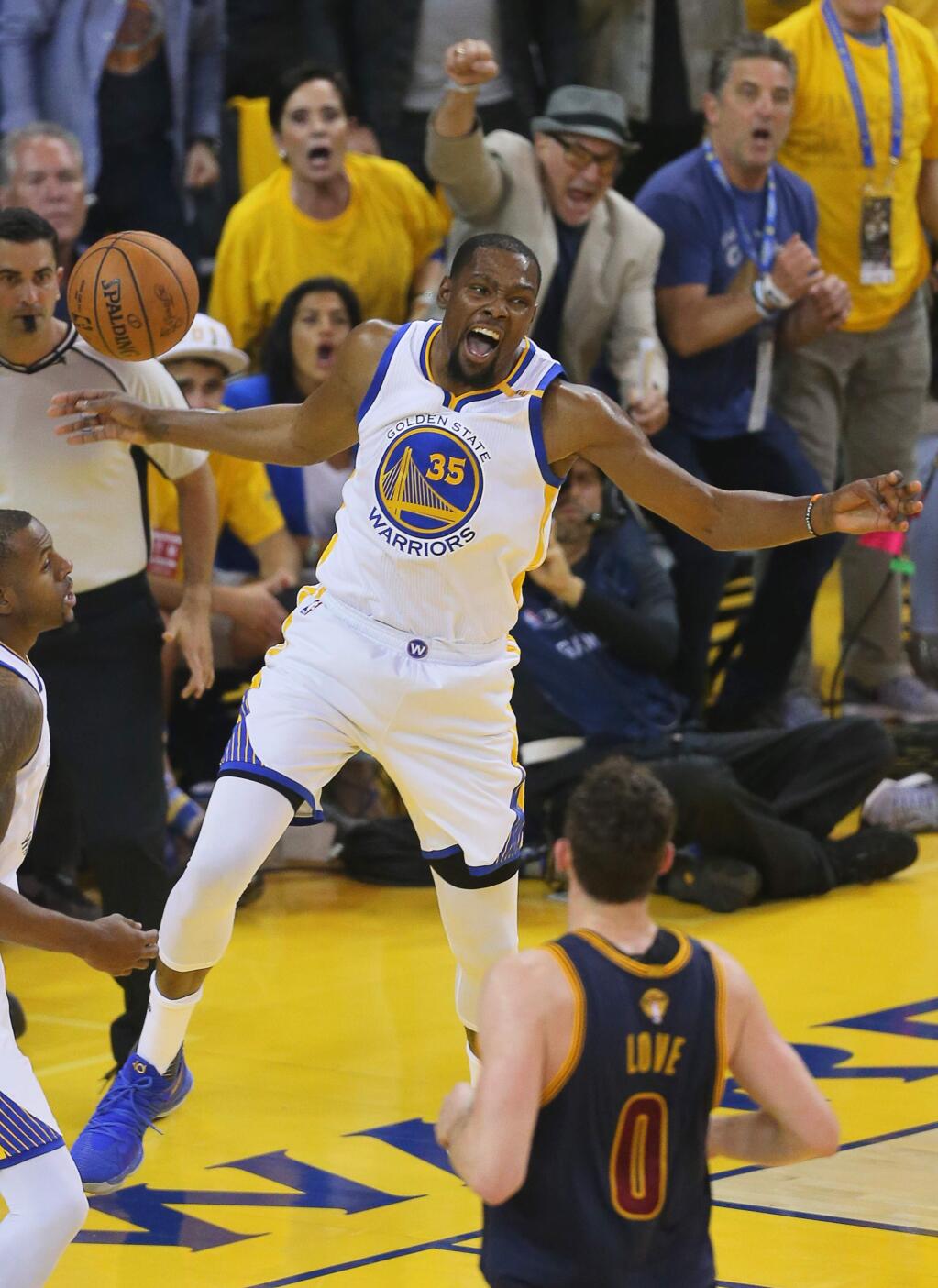 Golden State Warriors forward Kevin Durant lets out a yell after dunking the ball against the Cleveland Cavaliers during game 1 of the NBA Finals in Oakland on Thursday, June 1, 2017. (Christopher Chung/ The Press Democrat)