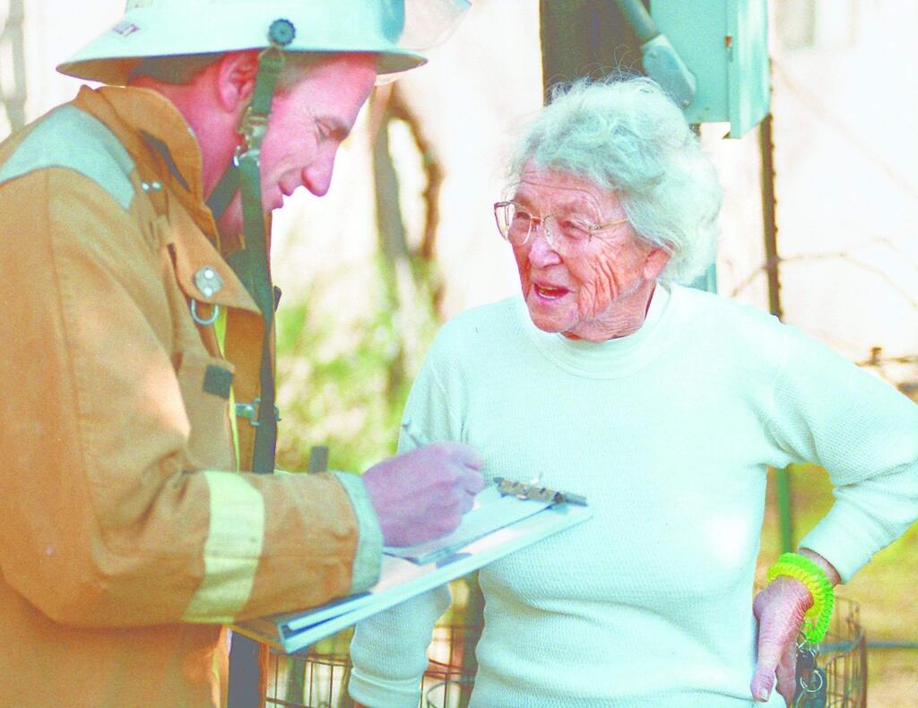 (File photo) Hattie Stone, 80, talks to Rincon Valley Fire Chief Doug Williams about the fire which destroyed her workshop, containing tools and three automobiles on Christmas day in 1998 (Chris Chung/The Press Democrat) 1998