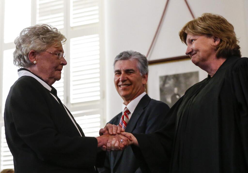 Acting Chief Justice, Lyn Stuart, right, congratulates Kay Ivey, left, after she is sworn in as Governor of Alabama, Monday, April 10, 2017, in Montgomery, Ala. (AP Photo/Butch Dill)