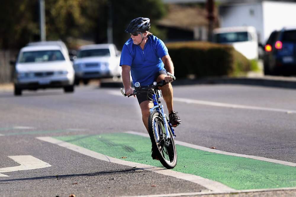 A cyclist uses one of the green painted bike lanes in Sonoma County. File photo. (John Burgess/The Press Democrat)