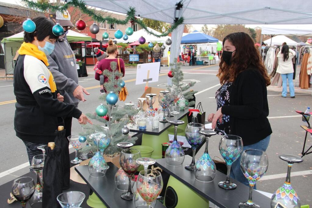 Dot Asylum owner Michelle Rohde helps customers at her booth Dec. 5, 2020, at the Shop and Stroll event in Cotati. Dot Asylum is one of 28 businesses scheduled to participate in Shop Into Spring. (Dave Wasson / Cotati Chamber of Commerce)