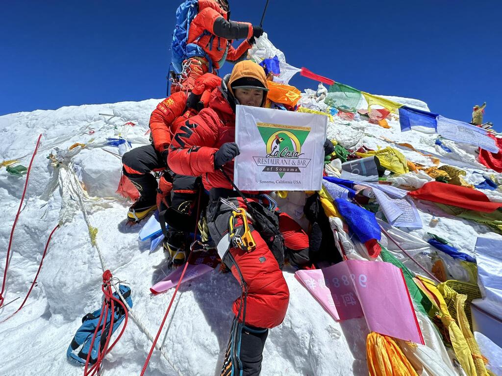 Mingma Dorchi Sherpa, a Nepali sherpa mountaineer and a professional trekking guide from Sankhuwasabha District in Nepal, smiles as he plants the La Casa flag at the summit of Everest. (Submitted)