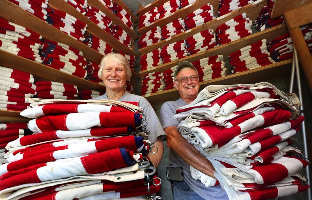 Air Force veteran Terry Thurman, left, and Marine veteran Steve Bosshard, pictured here in 2014, with some of the 1,000 caskets flags, each numbered and bearing the name of a veteran, that they and fellow volunteers place around the Santa Rosa Memorial Park on Memorial Day. (The Press Democrat file)