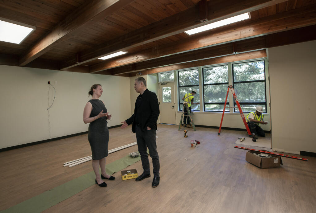 As construction work wraps up, Charlotte Hajer, senior director of the Community Mental Health Hub at Hanna talks with CEO Cameron Safarloo in one of the large  multipurpose rooms the will be used for classes, meetings and bilingual services on Tuesday, May 23, 2023.  (Robbi Pengelly/Index-Tribune)