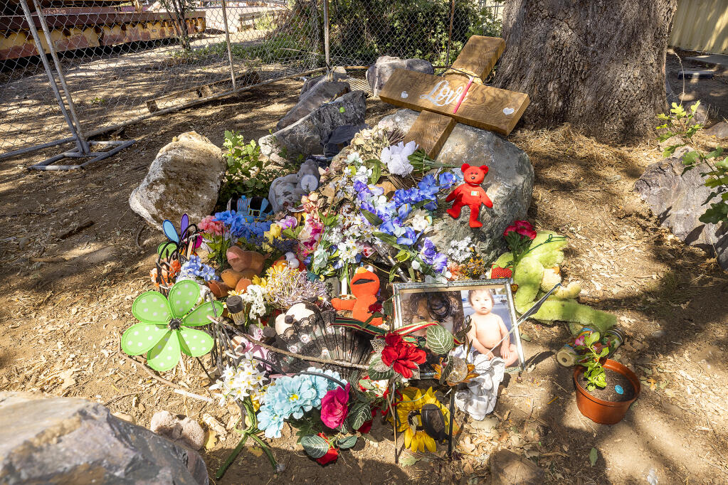 A memorial on the site where a 13-month-old boy was found dead on Brush Street in Ukiah on August 3, 2022. A defendant in the case has been charged with second-degree murder. (John Burgess/The Press Democrat)
