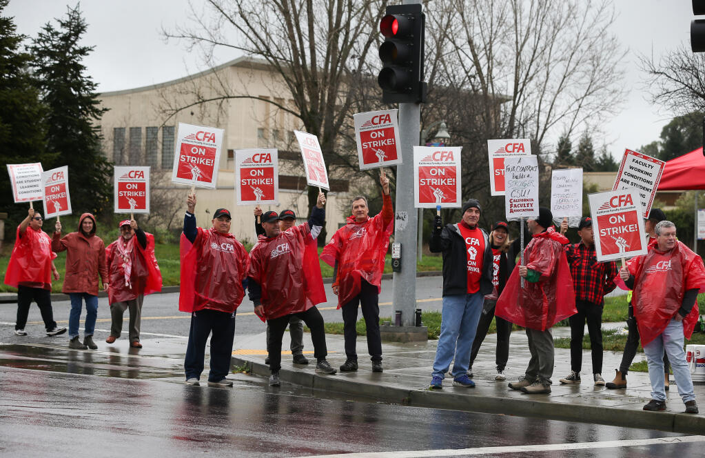 Sonoma State University staff picket at the Rohnert Park Expressway entrance to the campus in Rohnert Park, Monday, Jan. 22, 2024. (Christopher Chung / The Press Democrat)