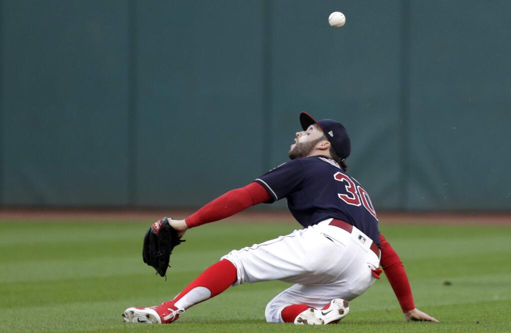 Cleveland Indians' Tyler Naquin bobbles a ball hit by Oakland Athletics' Dustin Fowler in the fifth inning of a baseball game, Friday, July 6, 2018, in Cleveland. Fowler was safe at first base for an RBI-single and Marcus Semien scored on the play. (AP Photo/Tony Dejak)