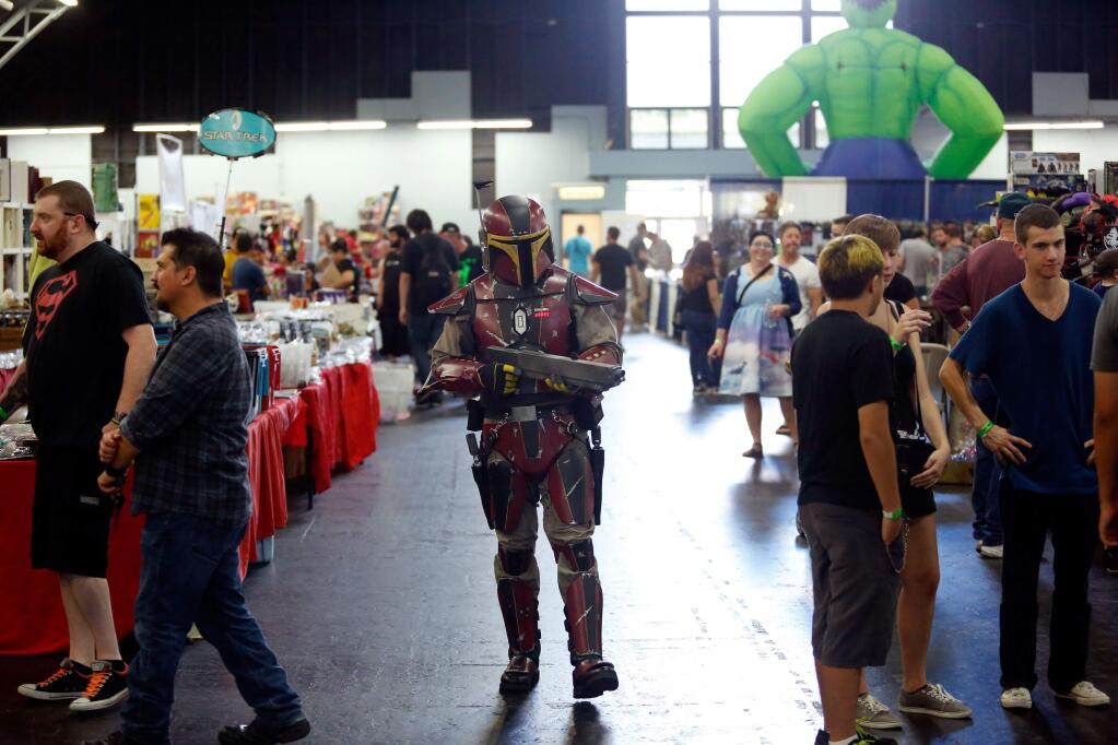 Russell Mann of the Mandalorian Mercs Costume Club, center, walks the aisles in his Star Wars-inspired costume during Toy Con at Sonoma County Fairgrounds in Santa Rosa, California on Saturday, September 26, 2015. (Alvin Jornada / The Press Democrat)
