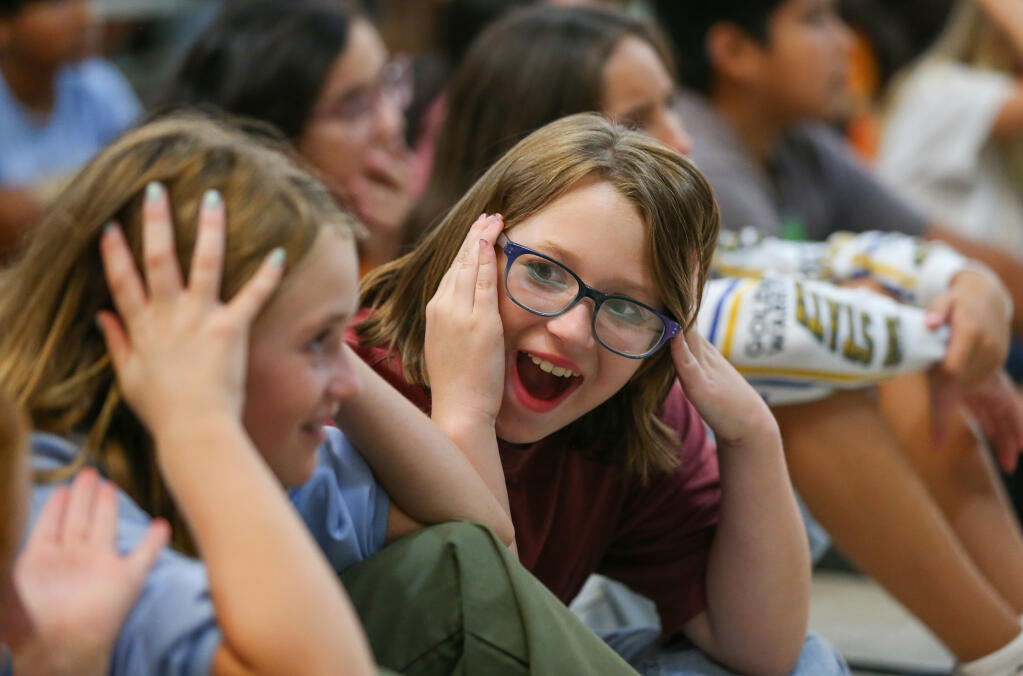 Fifth-graders Sofia Andrews, right, and Kolette Wood learn a word in sign language during a Common Ground Society presentation at Binkley Elementary Charter School in Santa Rosa, Monday, Aug. 21, 2023. (Christopher Chung / The Press Democrat)