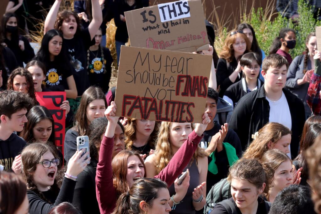 Students cheer and hold signs in the main quad after a campus walkout in protest of school safety at Maria Carrillo High School, Friday, March 3, 2023, in Santa Rosa. (Darryl Bush / For The Press Democrat)