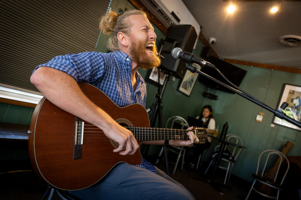 Jake Stotlemeyer, 32, performs under the name “King of Scroundrels” on open mic night at BREW in Santa Rosa, Tuesday, Aug. 1, 2023. (John Burgess / The Press Democrat)