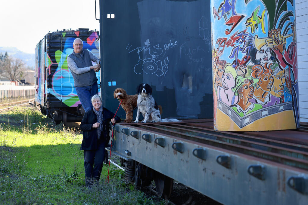 From left, Rail Arts District Napa President Chuck McMinn and Director Shelly Willis and McMinn’s dogs, Jessie and Barclay, in Napa, Thursday, Jan. 4, 2024. (Beth Schlanker / The Press Democrat)