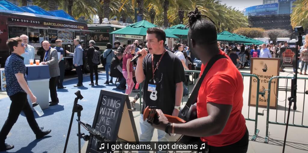 Ryan Woodard, 16, sings “Gravity” by John Mayer outside of the Anaheim Convention Center in April 2023. (Screenshot from YouTube video by guitaro5000)