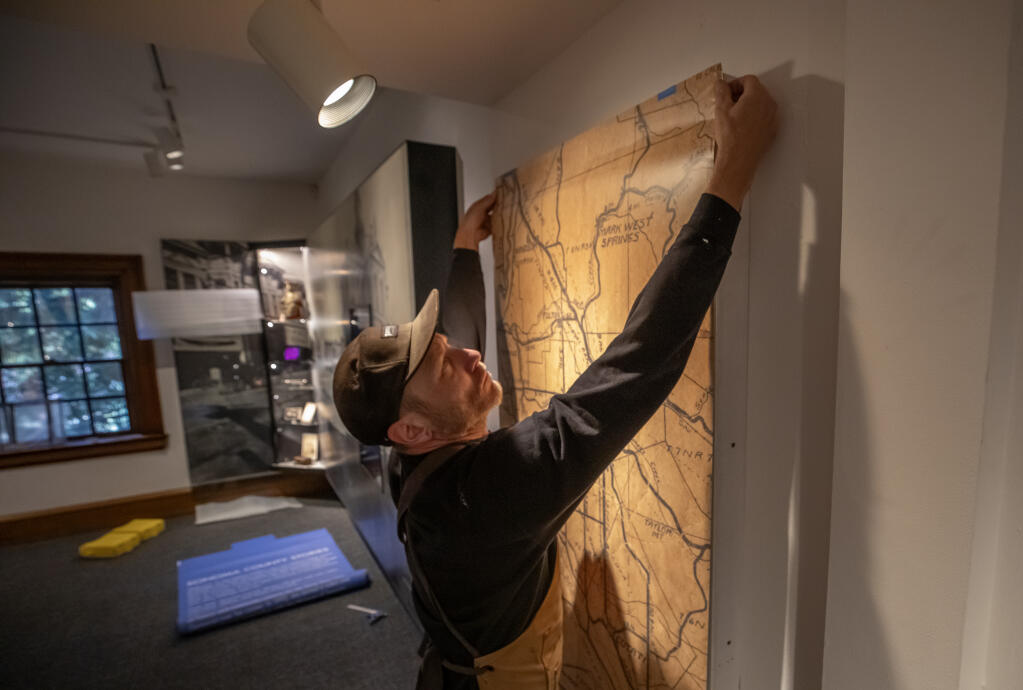 The “Sonoma County Stories” exhibit is under final construction as Jason Moore with Gizmo Art prepare a historical Sonoma County map display on the upper level of the Sonoma County Museum in Santa Rosa, Friday Sept. 1, 2023. (Chad Surmick / The Press Democrat)