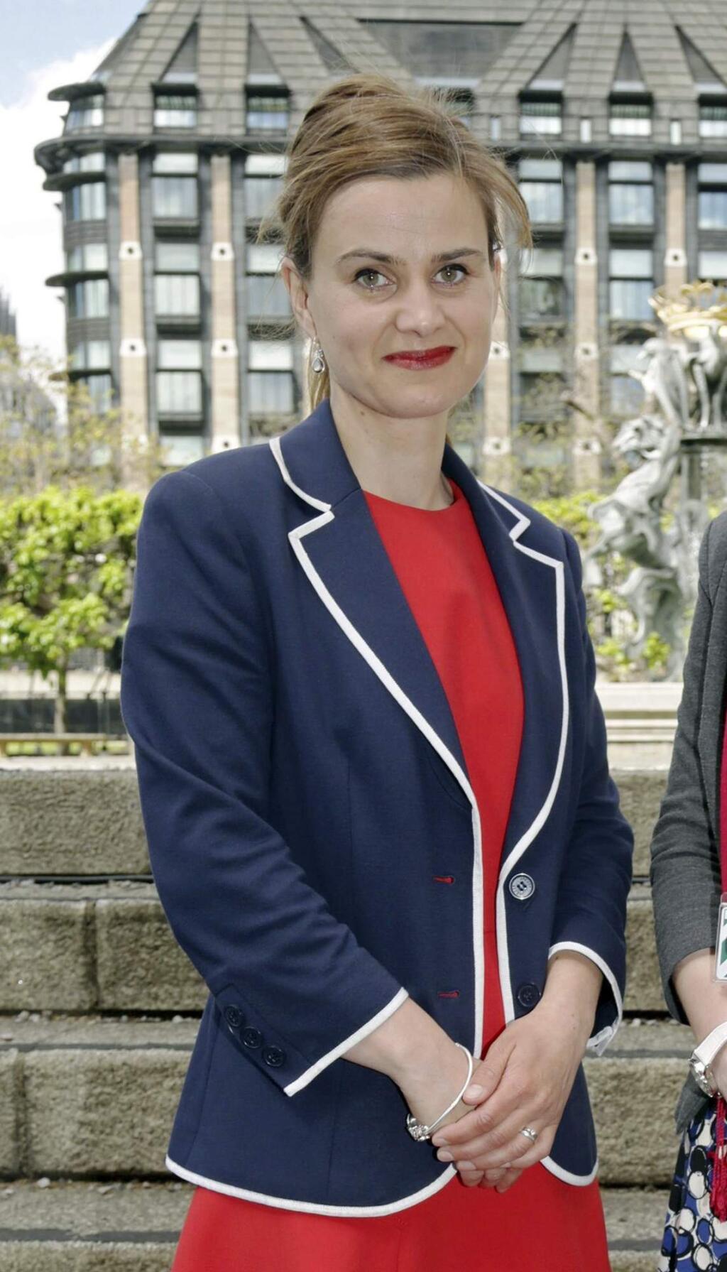 FILE - In this May 12, 2015 file photo, Labour Member of Parliament Jo Cox poses for a photograph. British lawmaker Cox was shot and killed near Leeds, in West Yorkshire, England, it has been reported, Thursday, June 16, 2016. (Yui Mok/PA via AP, File)