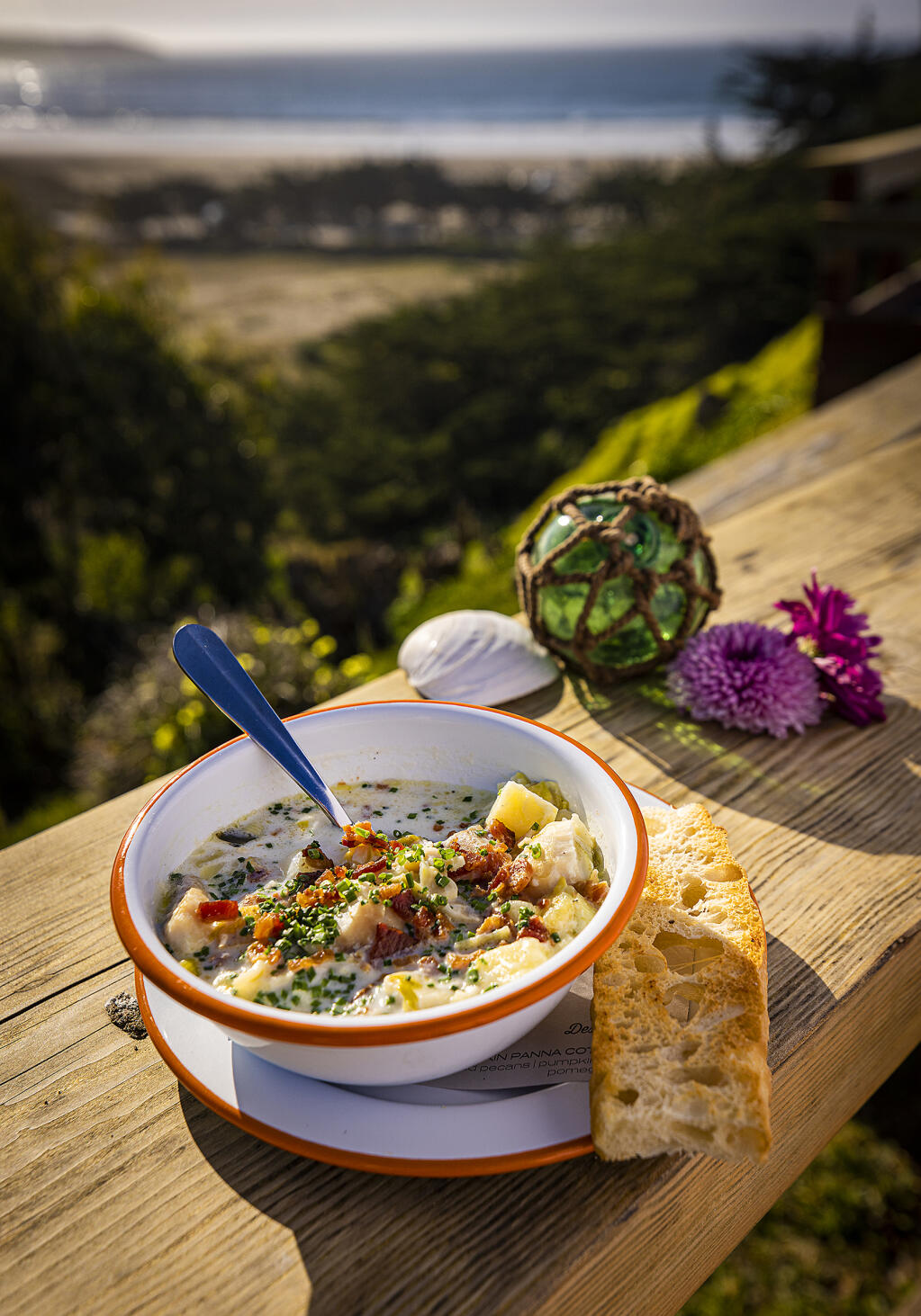 Coastal Kitchen chef Jennifer McMurry serves classic milk-based clam chowder with chopped clams, rock cod, potatoes and leeks garnished with bacon and chives with housemade focaccia and a view overlooking Dillon Beach. (John Burgess/The Press Democrat)