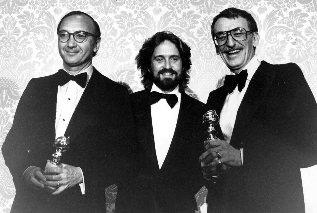 FILE- In this Jan. 29, 1978, file photo Neil Simon, Michael Douglas and Herbert Ross pose after Simon and Ross each won awards during the Golden Globe ceremony in Los Angeles. Simon, a master of comedy whose laugh-filled hits such as 'The Odd Couple,' 'Barefoot in the Park' and his 'Brighton Beach' trilogy dominated Broadway for decades, died on Sunday, Aug. 26, 2018. He was 91. (AP Photo, File)
