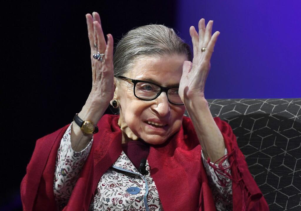 In this Oct. 3, 2019 photo, U.S. Supreme Court Justice Ruth Bader Ginsburg claps after listening to students sing opera at Amherst College in Amherst, Mass. Supreme Court Justice Ruth Bader Ginsburg is the winner of this year's $1 million Berggruen Prize for philosophy and culture. The award announced Wednesday by the Los Angeles-based Berggruen Institute honors Ginsburg for her pioneering legal work for gender equality and her support for the rule of law. The institute says Ginsburg will direct the money to charity. (AP Photo/Jessica Hill)