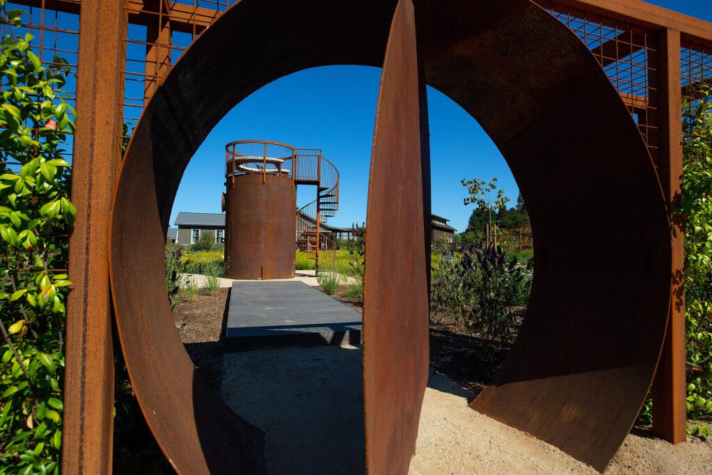 Lisa and John Malloy's stargazing tower, which was created from a large water tank by landscape designer Jake Moss, is seen through the revolving garden door, at the Malloy's home in Healdsburg, California, on Friday, August 2, 2019. (Alvin Jornada / The Press Democrat)