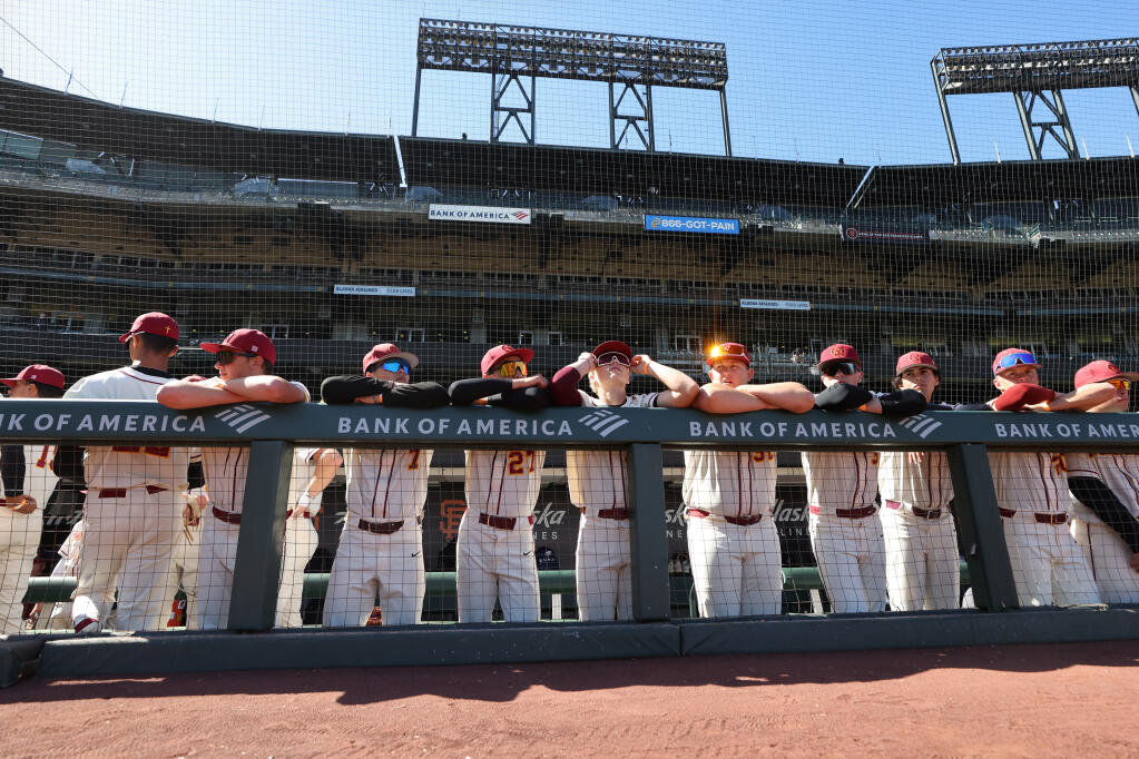 Cardinal Newman baseball players look out from the dugout before their game against Ukiah at Oracle Park in San Francisco on Monday, April 29, 2024.  (Christopher Chung/ The Press Democrat)