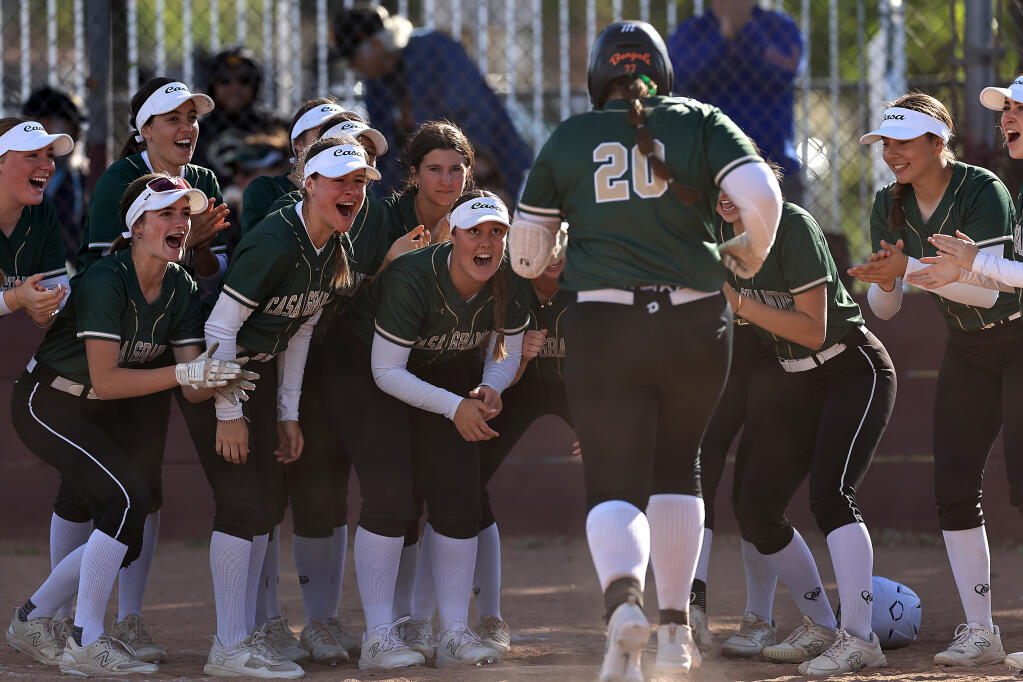 Lila Partridge is mobbed at home plate after smacking a solo home run against Vintage High School in Napa, Friday, April 26, 2024 to give Casa the go-ahead run and a 4-3 Vine Valley Athletic League win. (Kent Porter / Press Democrat)
