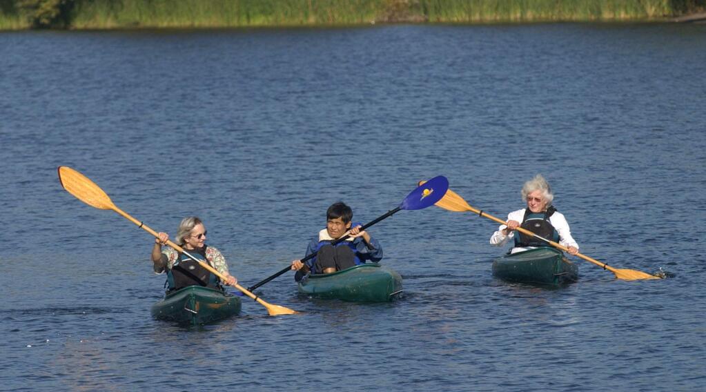 Anne Giles, left, and Diane Giles, right, paddle with their autistic son Sheldon, 42, at Spring Lake on a Sunday outing. (PD FILE)