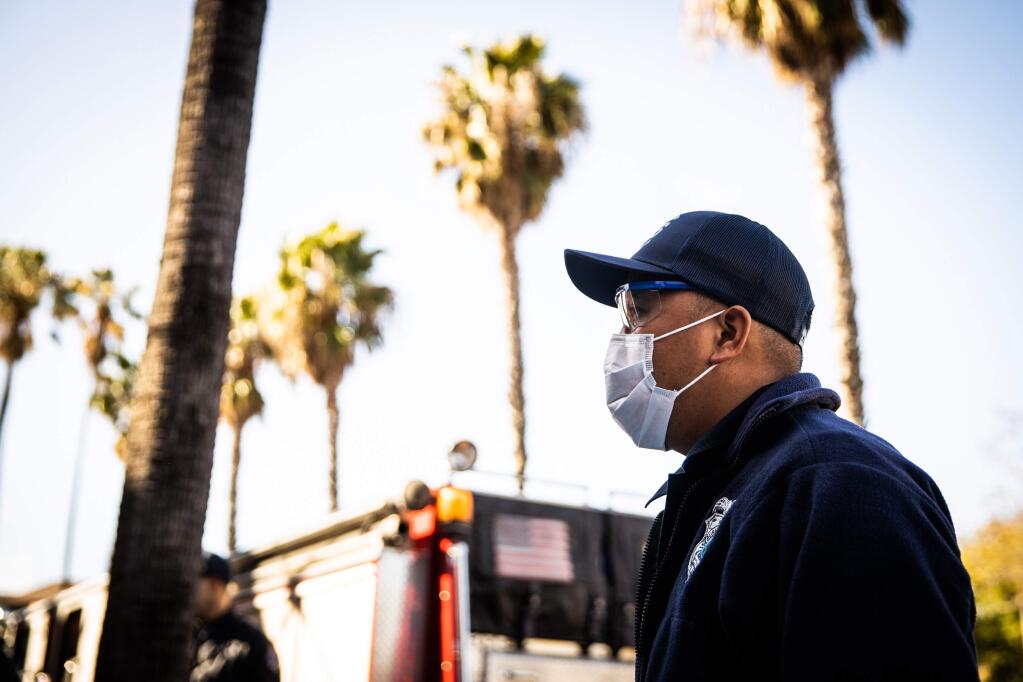 Santa Clara County EMT Twi Ford wears personal protective equipment to protect himself from the coronavirus while responding to a call in San Jose, California on March 19, 2020. MUST CREDIT: Photo for The Washington Post by Max Whittaker