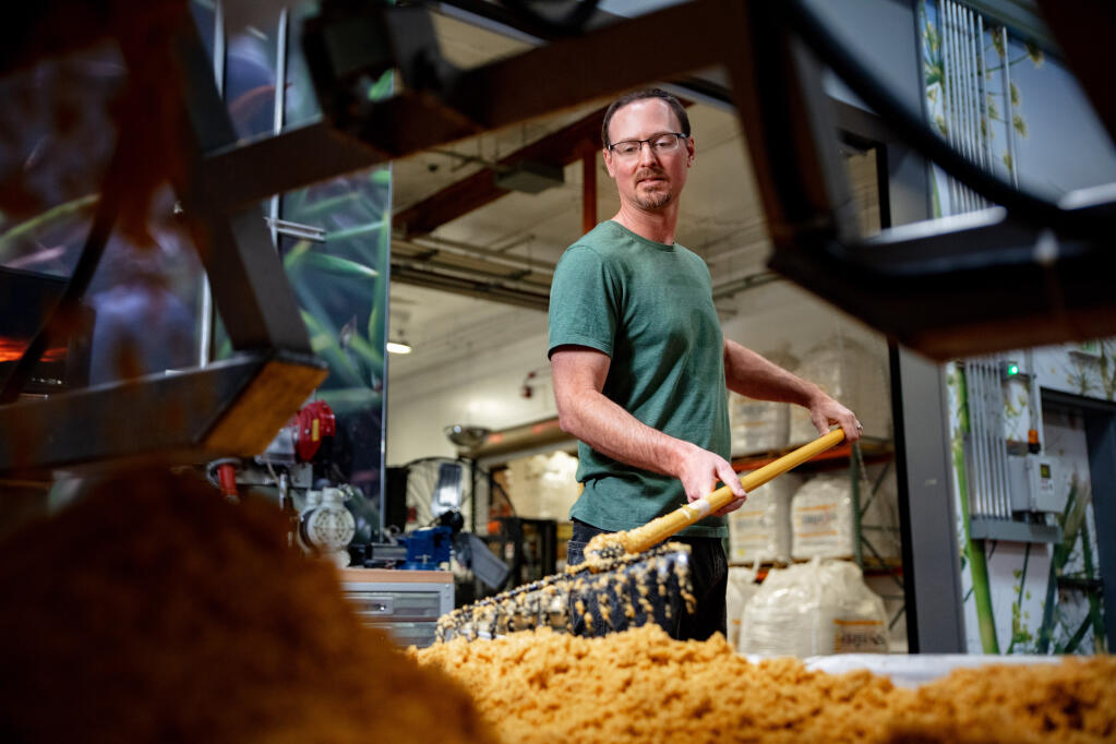 Jeff Duckhorn, Purple Brands master distiller, on April 16, 2019, rakes mash used in production of Redwood Empire brand whiskeys at the Graton distillery in west Sonoma County. (Purple Brands)