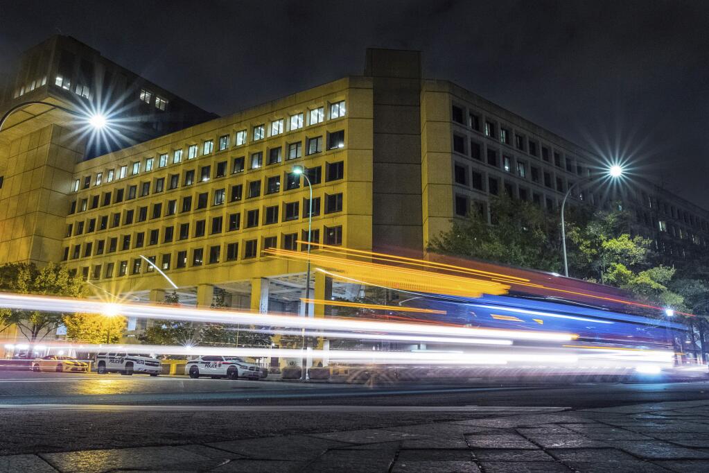 FILE - In this Nov. 1, 2017, file photo, traffic along Pennsylvania Avenue in Washington streaks past the Federal Bureau of Investigation headquarters building. The National Republican Congressional Committee said Tuesday that it was hit with a 'cyber intrusion' during the 2018 midterm campaigns and has reported the breach to the FBI. (AP Photo/J. David Ake)