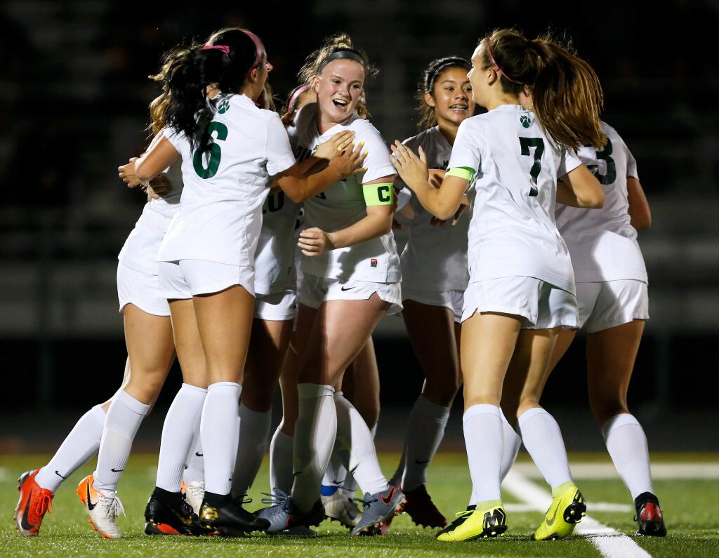 Maria Carrillo's Brynn Howard, center, is surrounded by her teammates to celebrate after she scored a goal after a free kick during the first half of the NCS Division 2 girls varsity soccer semifinal playoff match between Maria Carrillo and Montgomery high schools in Santa Rosa on Wednesday, Feb. 26, 2020. (Alvin Jornada / The Press Democrat)