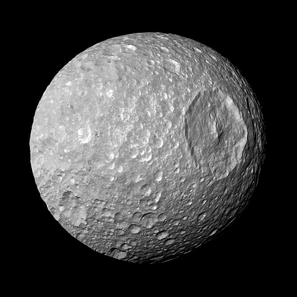 This Feb. 13, 2010 image provided by NASA shows Saturn's moon Mimas and it's large Herschel Crater, captured by the Cassini spacecraft. The crater is 130 kilometers (80 miles) wide. Astronomers have reported the best evidence yet of a vast, relatively new ocean beneath the icy exterior of Mimas, believed between 5 million and 15 million years old. The findings were published Wednesday, Feb. 7, 2024, in the journal Nature. (NASA/JPL-Caltech/Space Science Institute via AP)
