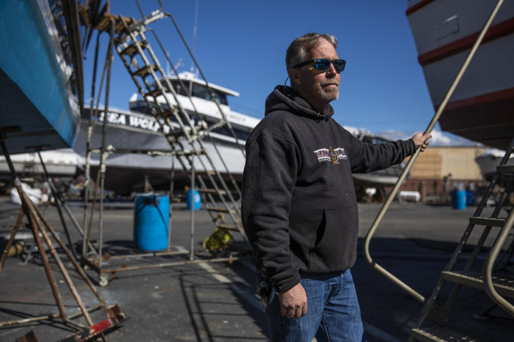 Jared Davis stands beside his charter fishing boat, Salty Lady, as it sits in dry dock in Richmond on Mar. 8, 2023. Photo by Martin do Nascimento, CalMatters