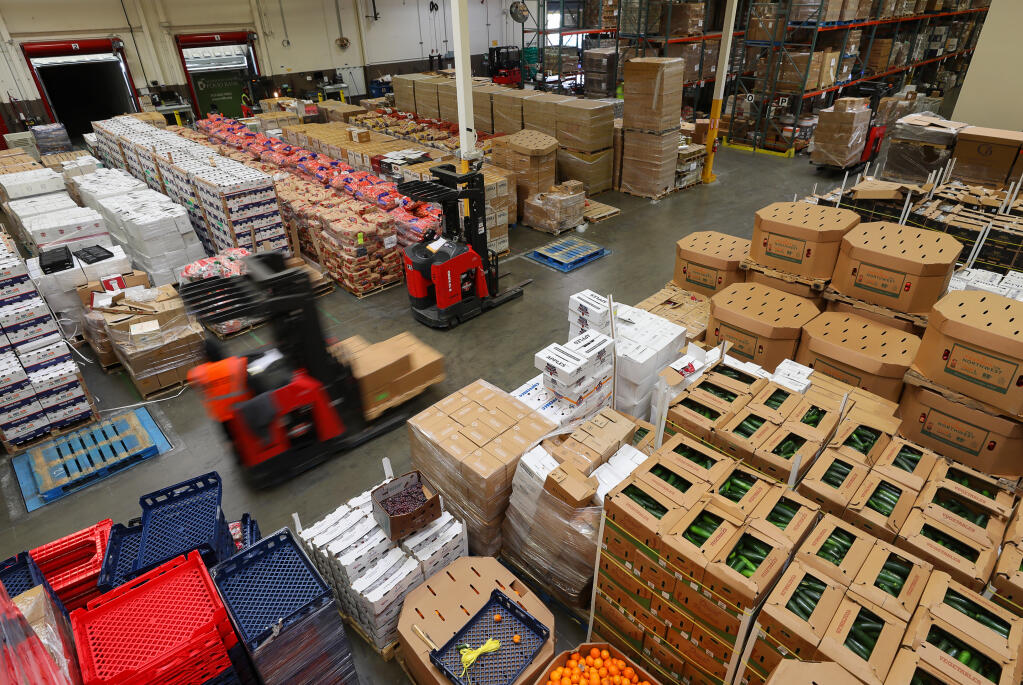 Forklift drivers move pallets of food around the Redwood Empire Food Bank warehouse in Santa Rosa, Friday, April 17, 2020. (Christopher Chung / The Press Democrat file)