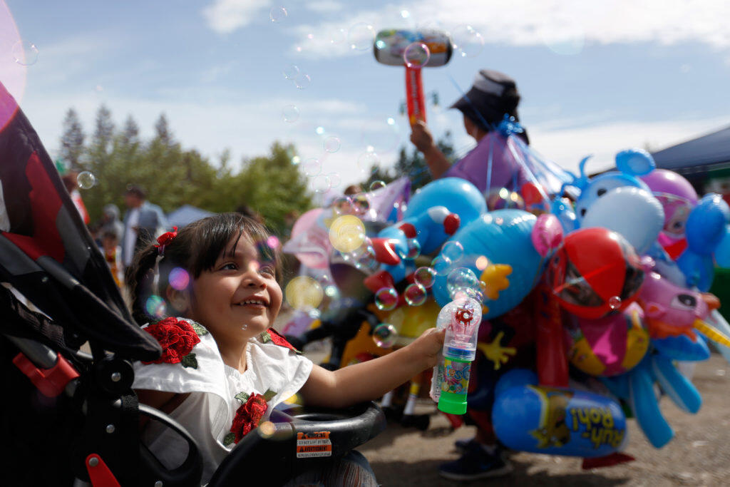 Aalyha Ramirez plays with a bubble blaster during the Roseland Cinco de Mayo festival, in Santa Rosa, Saturday, May 5, 2018. (Alvin Jornada / The Press Democrat file)